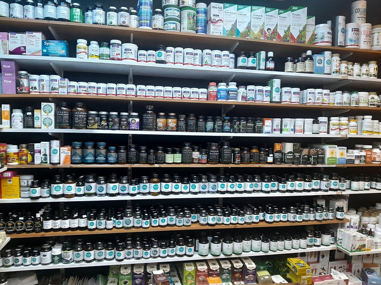 Shelves stocked with various health supplements and vitamins in a health store
