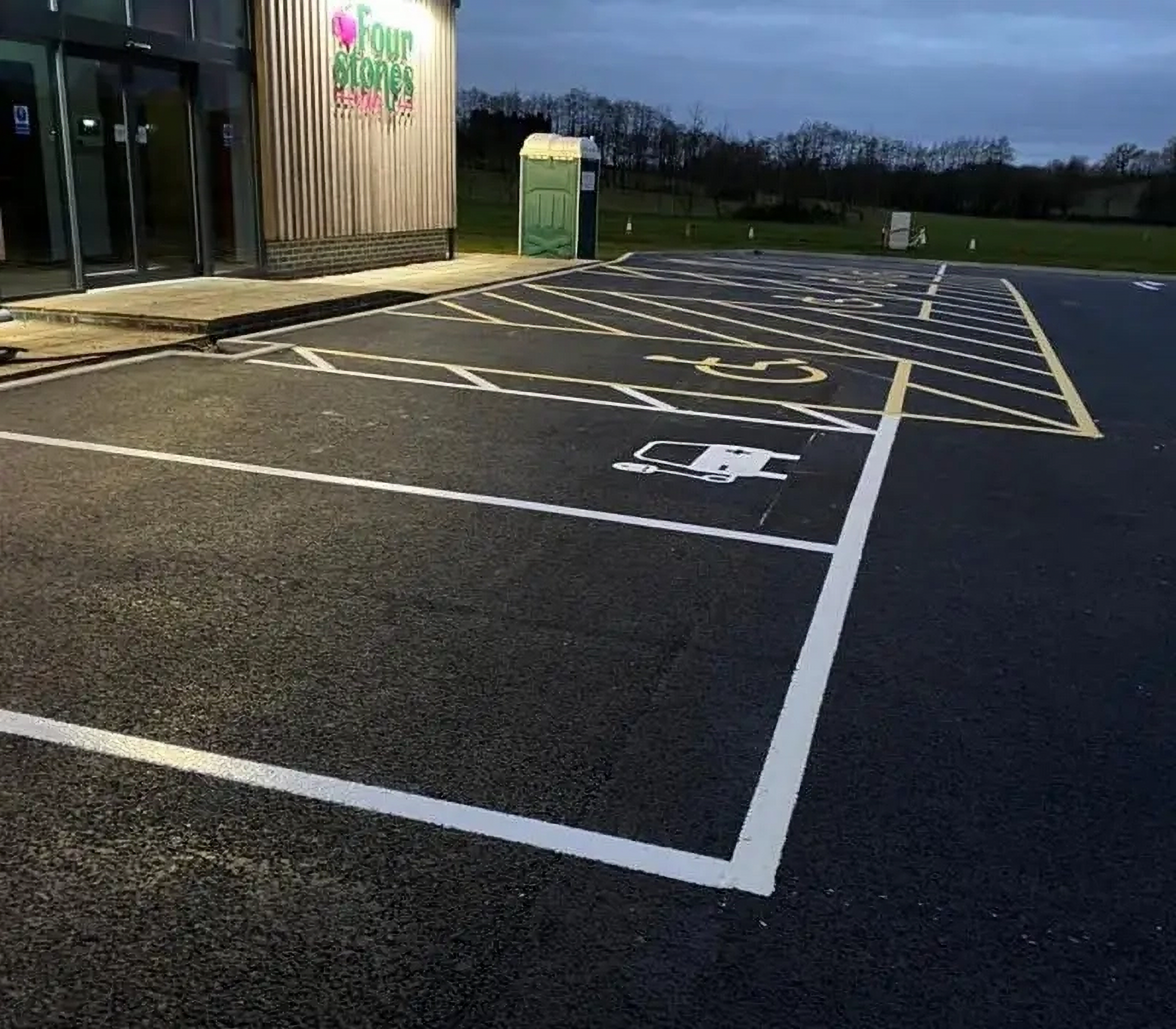 Newly painted yellow and white hatchings for an accessible disabled parking bay