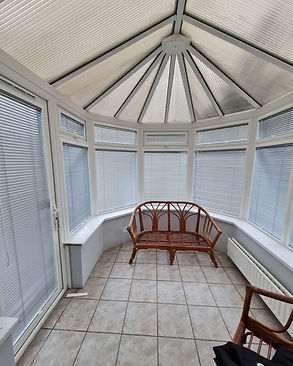 Conservatory blinds installed on sloped roof and side windows.