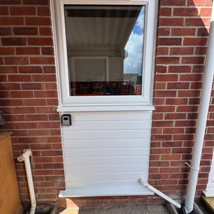 White uPVC stable door installed on a red brick house wall