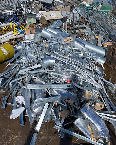 Large pile of silver galvanized metal scaffolding clamps and construction scrap
