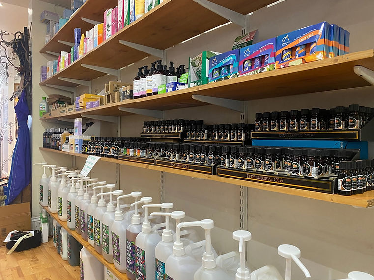 Dark wooden store shelves filled with various tincture bottles, supplement containers, and health products