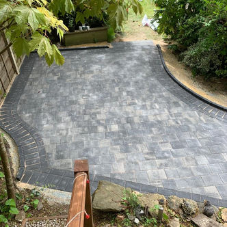 Grey block paved driveway with sweeping curved design