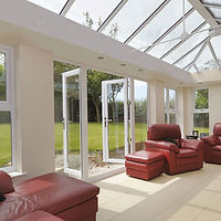 Sunlit conservatory with glass ceiling and walls