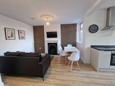 Modern living room and kitchen with light wood flooring