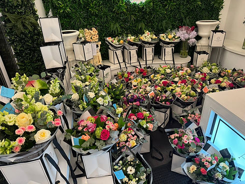 An overhead view of a florist workshop area filled with boxes of freshly prepared flower bouquets