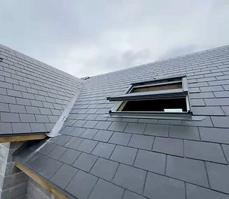 A roof featuring a window and a skylight, allowing natural light to enter the space below