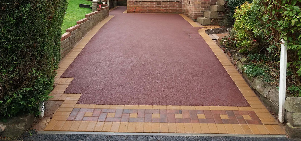 A driveway featuring a red and brown tarmac surface, showcasing a unique color pattern and texture