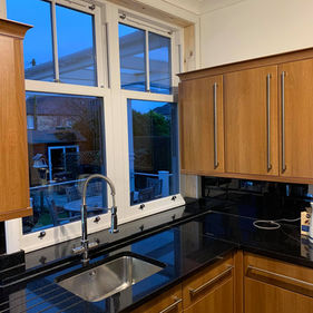 Kitchen with wooden cabinets and a black countertop
