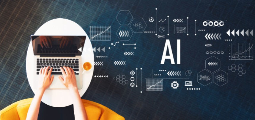 AI written in the background next to a table with a laptop on it and a person typing on the laptop