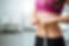 Slim young woman measuring her thin waist with a tape measure, close up.jpg