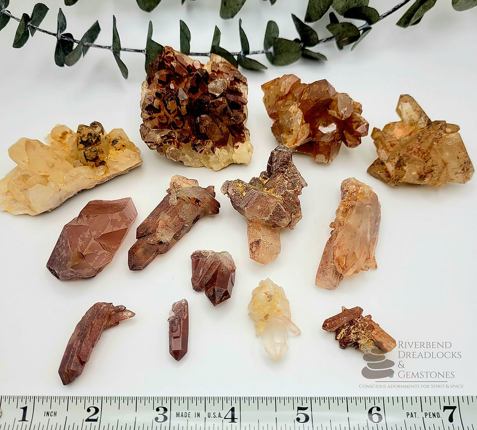 Thumbnail: Close up of several Hematoid Quartz Raw crystal clusters and points, ranging from 1.0 to 2.5 inches. A tape measure is placed nearby for size reference.