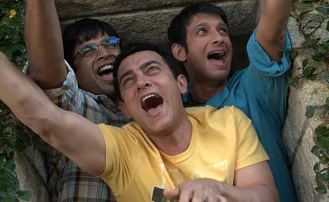 3 students cheering