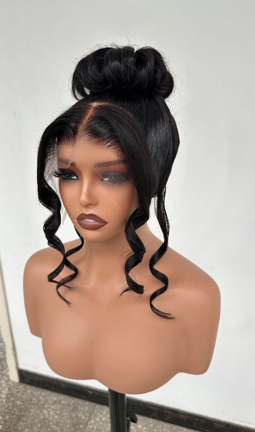 Thumbnail: Natural black 360 transparent lace wig styled in an elegant high bun updo.