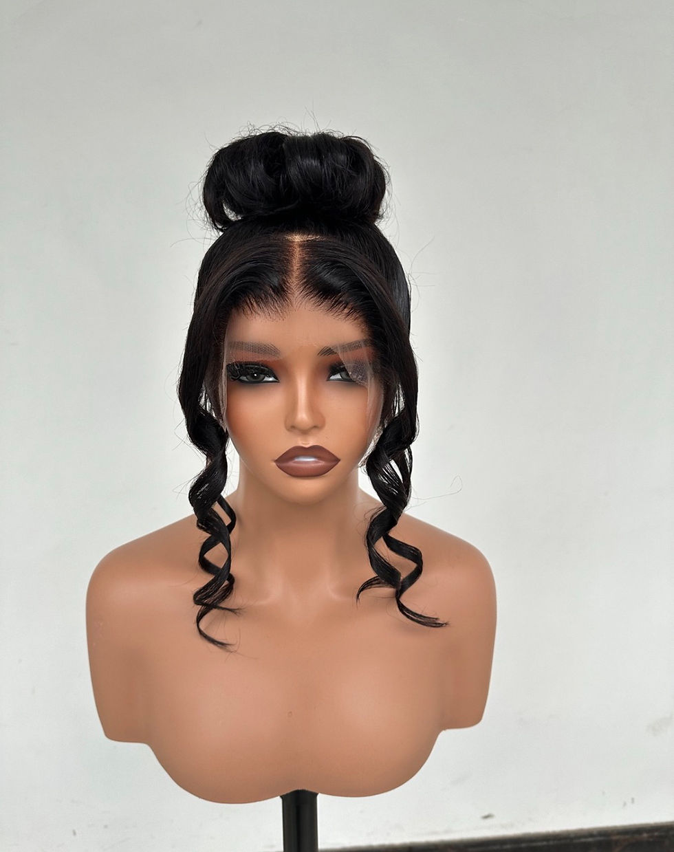 Thumbnail: Pre-styled black updo wig with 360 lace, high bun and soft face-framing curls.