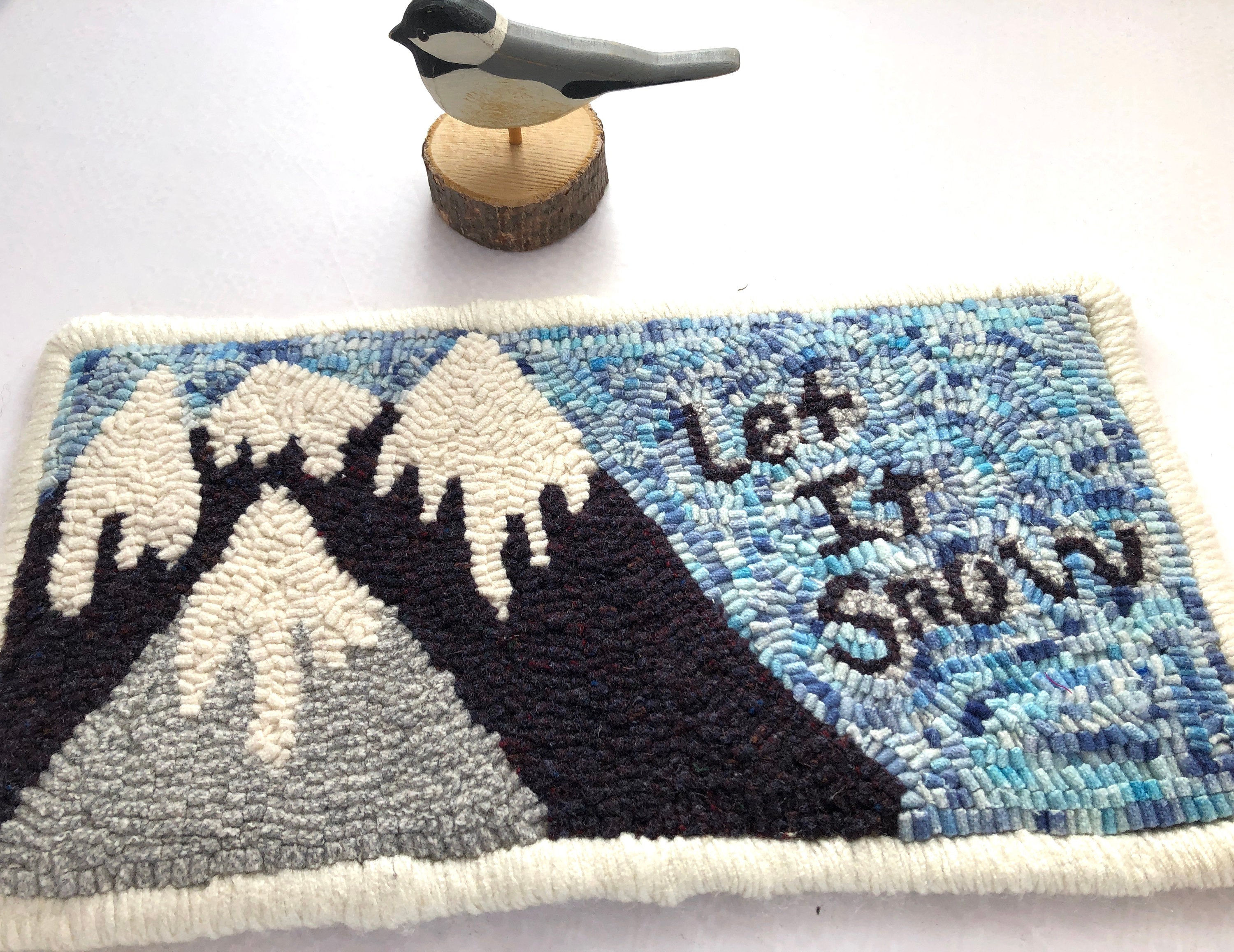 Hand hooked wool rug with mountains let it snow