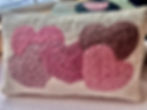 small cottage style hand hooked pink heart pillow on linen
