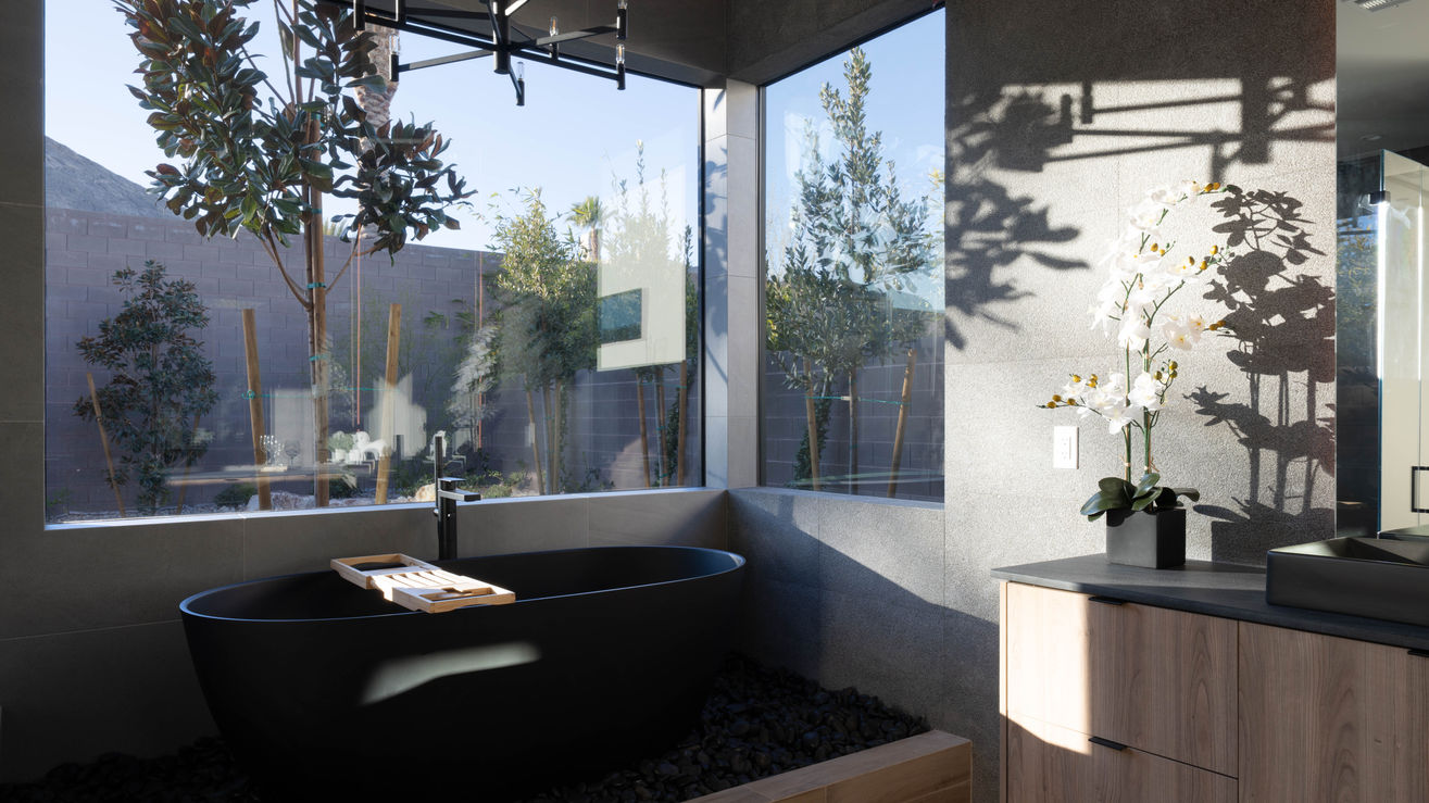 The Primary bathroom luxury black tub.