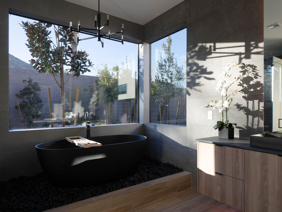 The Primary bathroom luxury black tub.