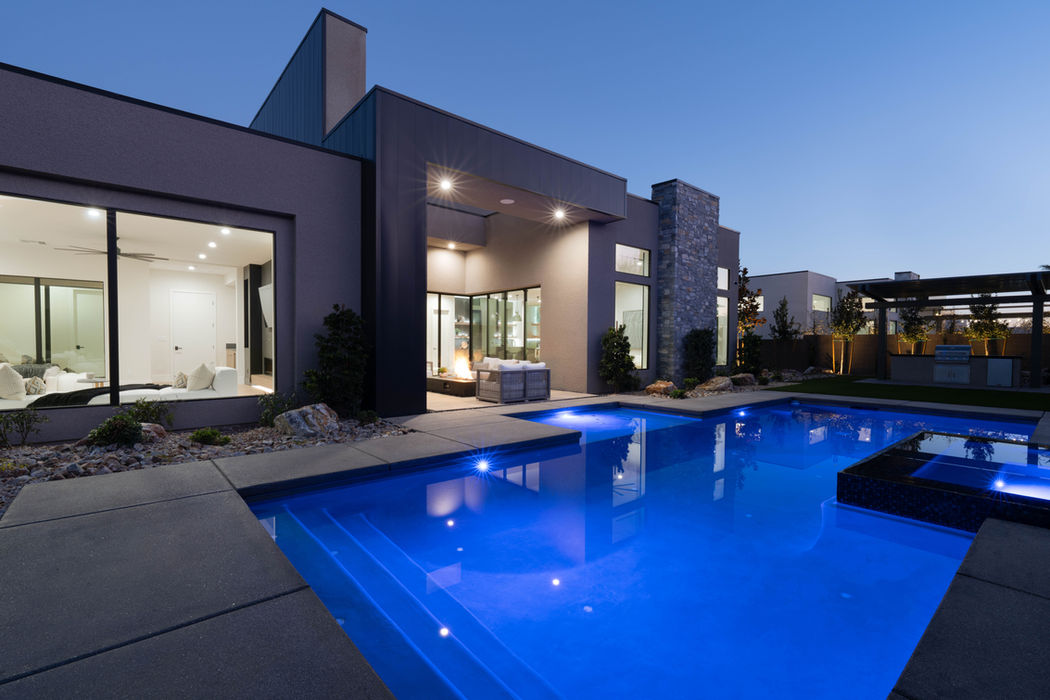 The backyard pool and spa at night.