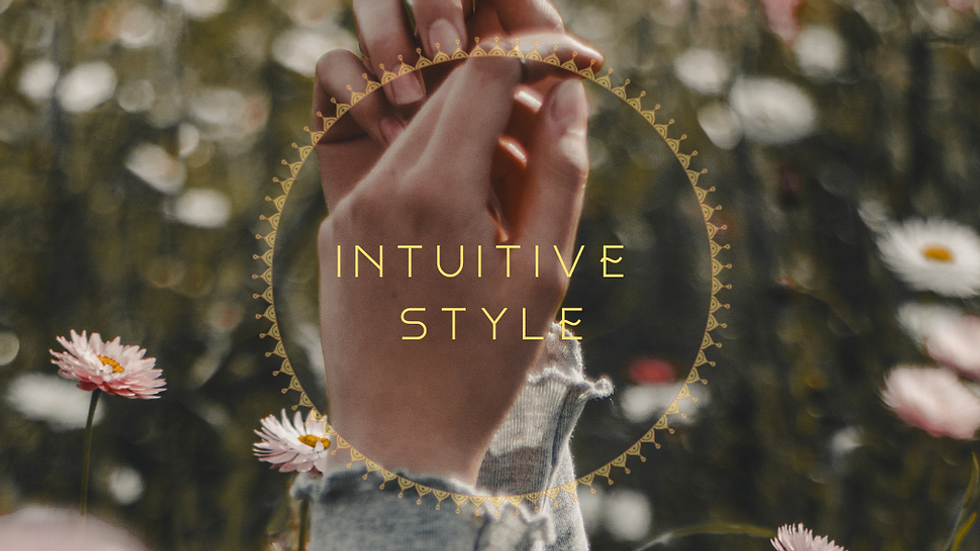 Hand raised among soft flowers — symbolising intuitive connection, emotional alignment, and nature-based living