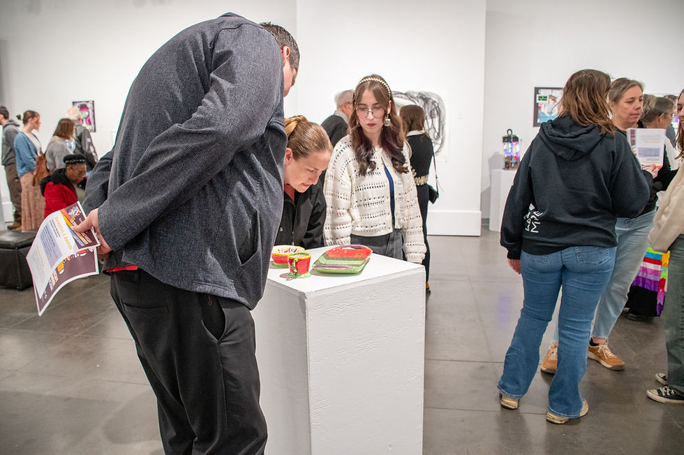 gallery visitors view clay artwork in 15th annual high school juried art show