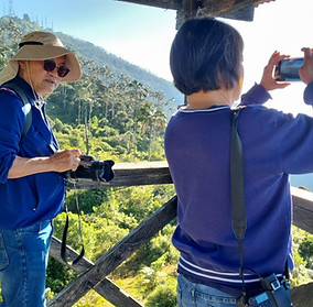 Two Chinese clients, a married couple, photographing wildlife in the Sierra Nevada de Santa Marta during an Ocampo Expedition