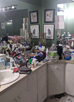 Before photo of a very cluttered bathroom