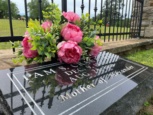 Vibrant pink cemetery flower arrangement in vase for bold graveside decoration