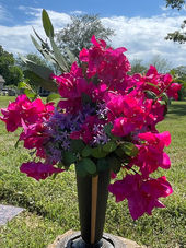 Bright yellow cemetery flower arrangement on headstone for cheerful memorial decoration at Bluff Cemetery