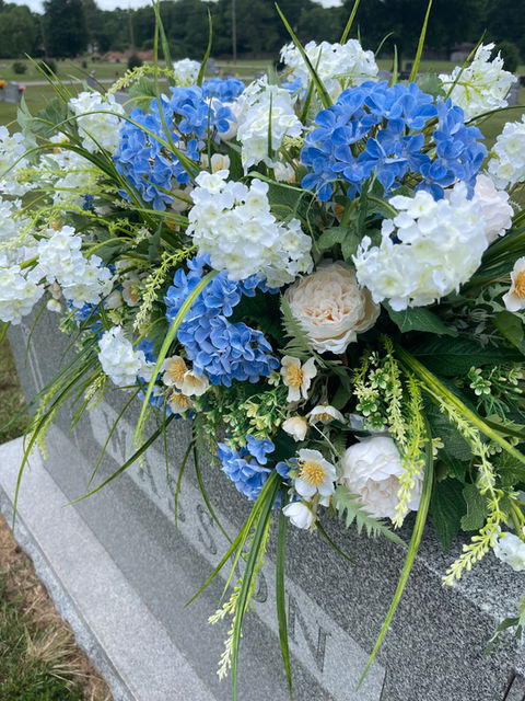 Beautiful Blue Cemetery Flowers premium headstone arrangement placed on a Memorial day florals for a family estate gravesite in Siloam Springs, Arkansas. Part of the custom cemetery collection at Golden Valley Silk Florals.