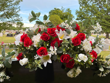 Red and white rose cemetery flower arrangement on headstone at Pinnacle Memorial Gardens, Rogers, Arkansas