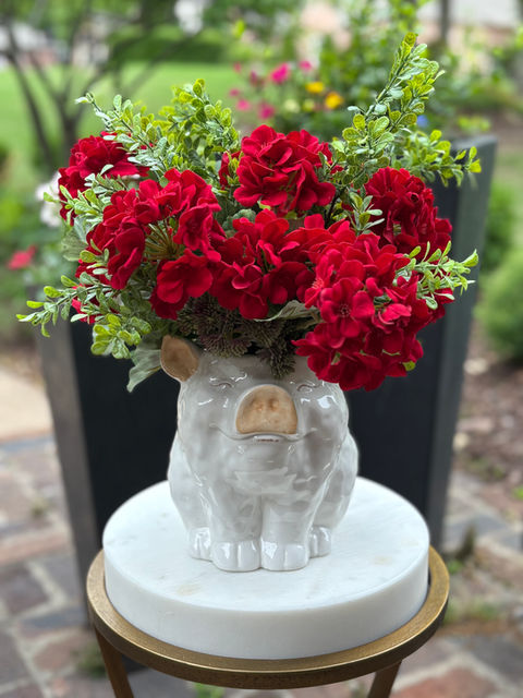 Red geranium silk floral arrangement in a decorative urn for home decor.