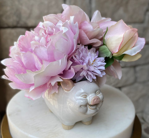 cheerful gift with spring roses and a happy pig vase
