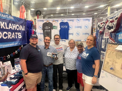 Troy takes a group photo with folks at the Oklahoma Democrats booth at the State Fair