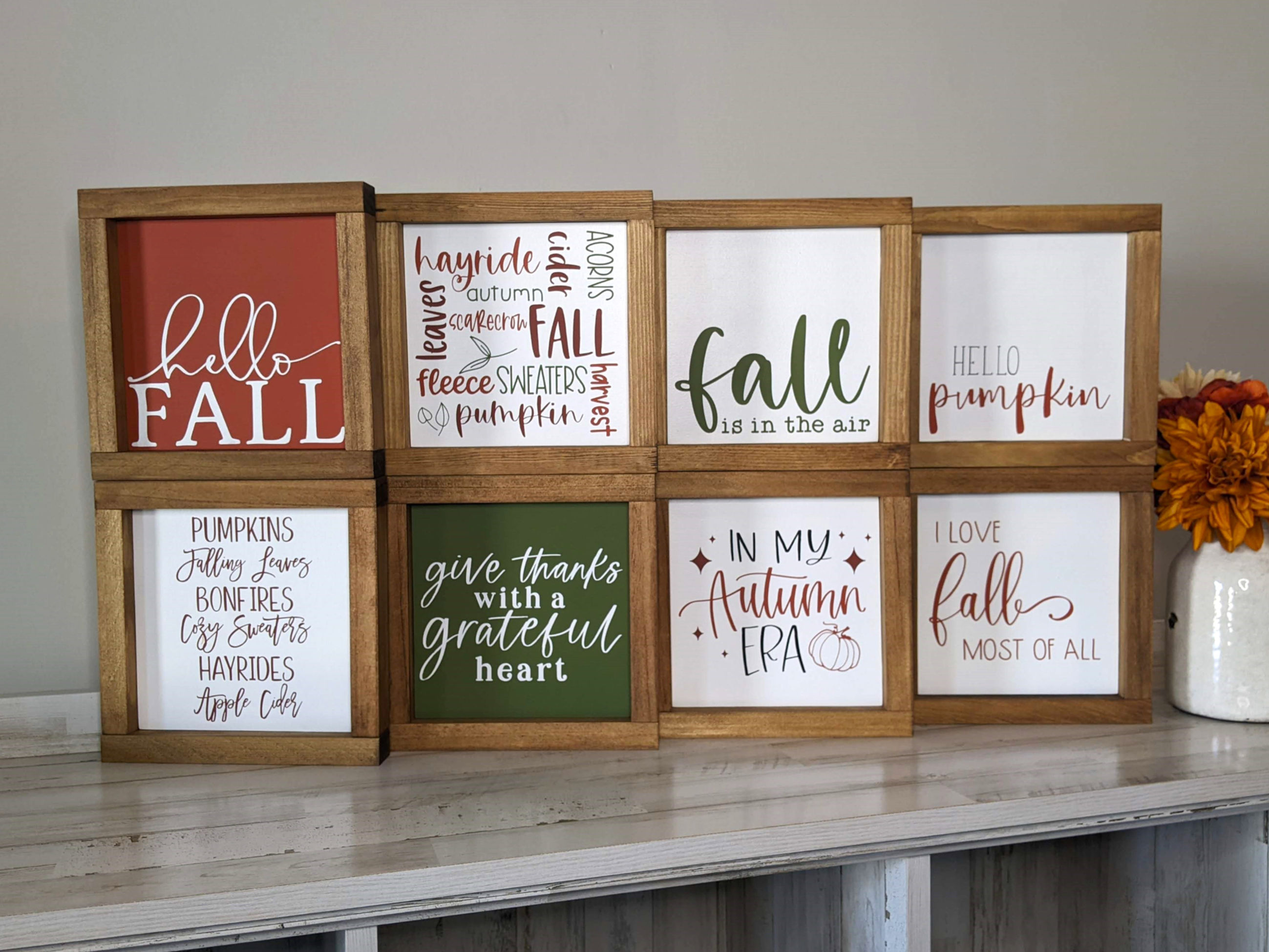 8 small framed fall signs with different fall sayings on them