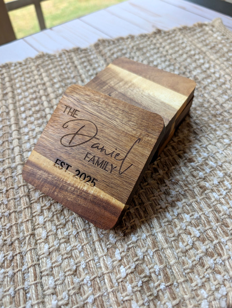 custom engraved acacia wood coaster leaning against a stack of coasters