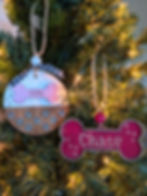 Personalized round dog ornament with pet name Izzy, bone shape and paw prints,  and red bone shape with pet name
