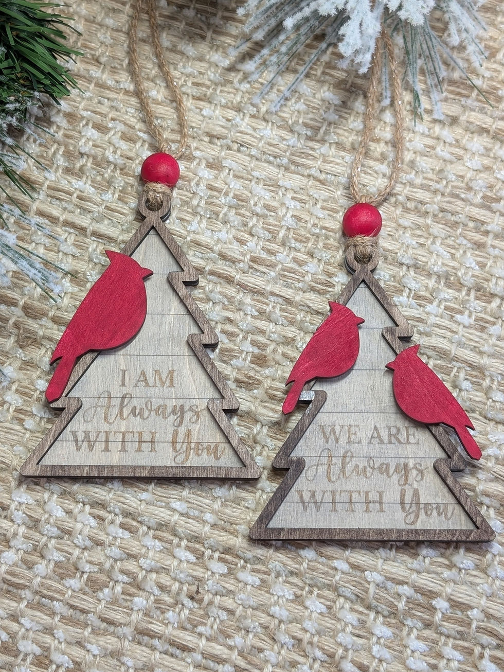 Red cardinal remembrance ornament with red wood bead and wood background saying “I Am Always With You,” hung on a Christmas t