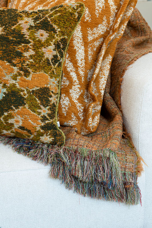 Plaid with long fringes on a sofa