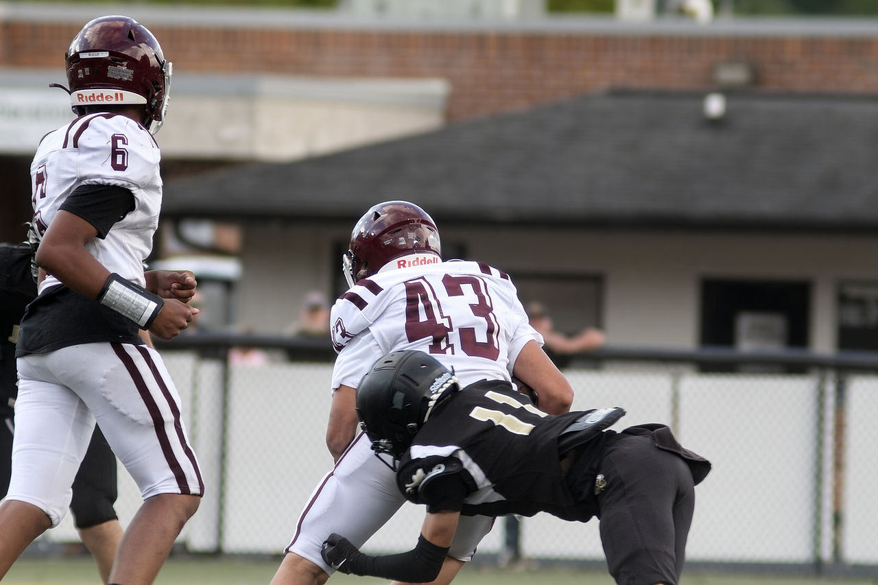 Abel Moore makes first contact to slow Swain's attempt to gain yards.