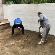 The Karmarong preparing the ground for cement and brick tiles
