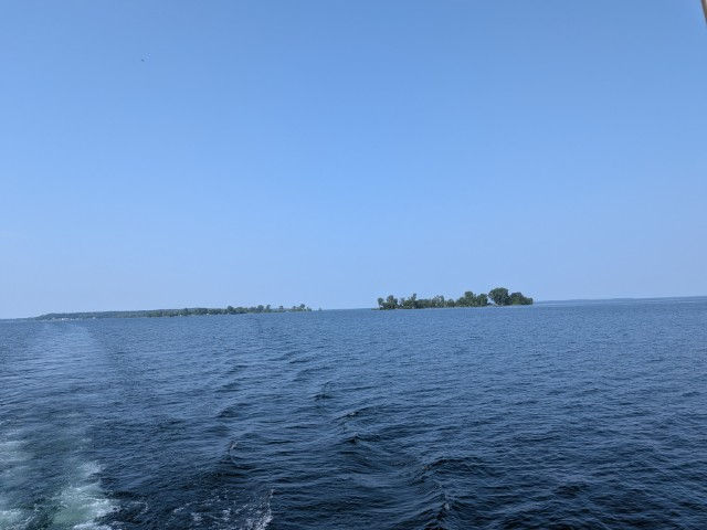 Behind the boat.