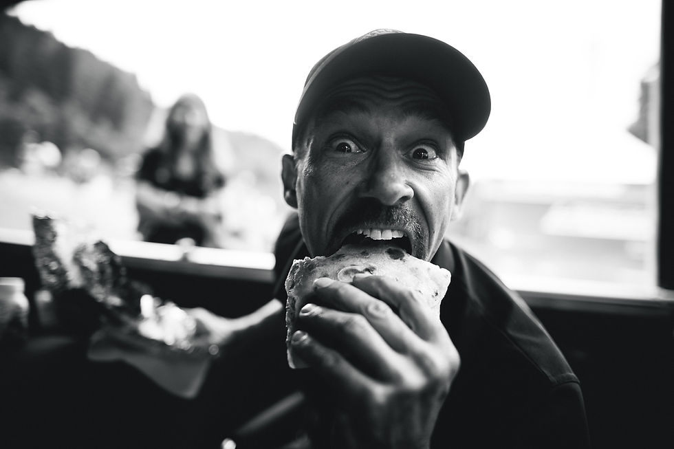 James Brickell pulling a funny face eating a sandwich