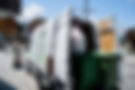 Verbier Green worker loading bins in va van in Verbier