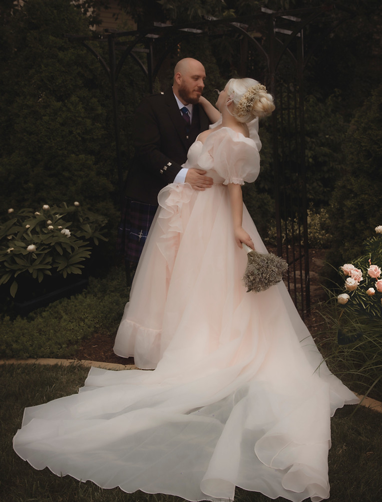 Moody bridal wedding photos in dark background pale pink selkie gown