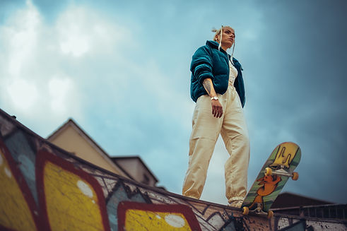 azafran skate wear - teal bomber jacket, skateboard and dean lane skate park half-pipe.jpg