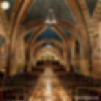 Interior of the Lower Basilica of Saint Francis in Assisi, showcasing its richly decorated arches, frescoes, and quiet atmosphere for prayer and reflection.