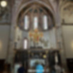 The image shows the Cross of San Damiano inside the Basilica of Saint Clare, an important Franciscan relic symbolizing Saint Francis's spiritual conversion.