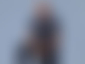 man with glasses and blue shirt